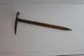 Vintage mountaineering ice axe on white wall Royalty Free Stock Photo