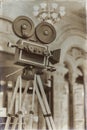 Vintage movie camera on a tripod, model. Processed with retro style. Cinema concept and other antiquities. For Royalty Free Stock Photo