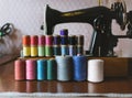 Vintage multicolor sewing threads on background of sewing machine