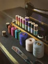 Vintage multicolor sewing threads on background of sewing machine Royalty Free Stock Photo