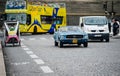 Vintage Mustang and rickshaw on Paris street