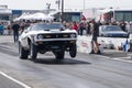 Vintage mustang wheelie at the starting line