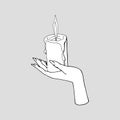 Vintage Mystic female Hand holding lit candle.