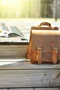 vintage natural leather backpack and books on gray rustic wooden stairs Royalty Free Stock Photo