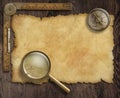 Vintage nautical compass and loupe on table with Royalty Free Stock Photo