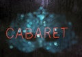 Vintage Neon Cabaret Sign With Bokeh Carnival Mask in Rainy Window Royalty Free Stock Photo