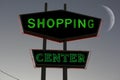 Vintage Neon Shopping Center Sign at night with Moon in background