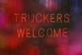 Vintage Neon Sign in Rainy Window Truckers Welcome