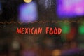 Vintage Neon Sign in Wet Rainy Window, Mexican Food