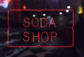 Vintage Neon Soda Shop Sign in Rainy Window Royalty Free Stock Photo