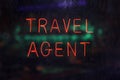 Neon Travel Agent Sign in Rainy Window