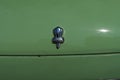 Vintage Nissan Figaro car emblem on the shiny surface of the green car in Manchester Royalty Free Stock Photo