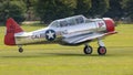 A Vintage North American Harvard aircraft lands on a grass airfield Royalty Free Stock Photo