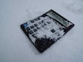 Vintage not working photocell calculator with snow-covered buttons stock image Royalty Free Stock Photo