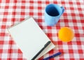 Vintage notebook with a cup and a fruit on the table waiting for Royalty Free Stock Photo