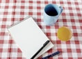 Vintage notebook with a cup and a fruit on the table waiting for Royalty Free Stock Photo