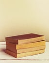 Vintage novel paperback books on wooden table. Copy space. Vertical image. Retro