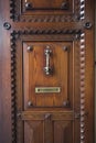 Vintage oak door in Spain with knock knob and mailbox labeled cartas