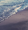 Vintage ocean wave at sunset, beach background