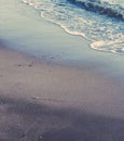 Vintage ocean wave at sunset, beach background