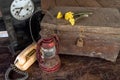 Vintage oil lamp ,old wooden box, old telephone , dry chrysanthemum flower and alarm clock on old wooden touch-up in still life Royalty Free Stock Photo