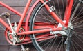 Old red bike on the background of a brown wooden wall Royalty Free Stock Photo
