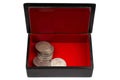 vintage old black and red casket with silver dollar coins