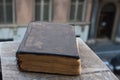 Vintage old book on stone, grunge textured cover. Retro styled image with blurred background.