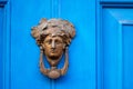 Vintage old bronze door knocker in the form of a female head
