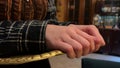 Vintage old cafe waitress holding a tray with her hands. Dark clothes interior close-up of service staff hands concept