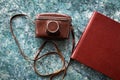 A vintage old camera in a brown leather case and stylish brown photo books Royalty Free Stock Photo