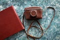A vintage old camera in a brown leather case and stylish brown photo books Royalty Free Stock Photo