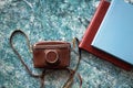 A vintage old camera in a brown leather case and two stylish brown and blue photo books Royalty Free Stock Photo