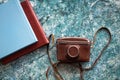 A vintage old camera in a brown leather case and two stylish brown and blue photo books Royalty Free Stock Photo