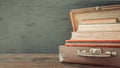Vintage old classic travel leather suitcases with stack of old books and albums Royalty Free Stock Photo