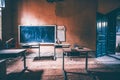 Vintage old destroyed classroom inside abandoned school with chalk board Royalty Free Stock Photo