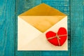 Vintage old envelope with red heart on blue wooden background Royalty Free Stock Photo