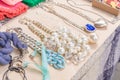 Vintage old-fashioned jewelry at flea market stall or car boot sale. Retro style pearl necklace Royalty Free Stock Photo