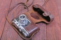 Vintage old film photo-camera in leather case Royalty Free Stock Photo