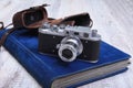 Vintage old film photo-camera in leather case and album Royalty Free Stock Photo