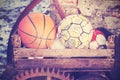 Vintage old film stylized used balls in basket. Royalty Free Stock Photo