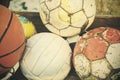 Vintage old film stylized used balls in basket. Royalty Free Stock Photo