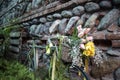 vintage an old green bicycle with a basket of flowers by a stone wall made of bricks and stones Royalty Free Stock Photo