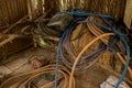 Vintage Old Hoses on Dirty Concrete Ground - Hay, Wood and Plastic Sheet in Messy Chicken Coop - Rural Vietnam Royalty Free Stock Photo