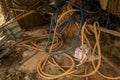 Vintage Old Hoses on Dirty Concrete Ground - Hay, Wood and Plastic Sheet in Messy Chicken Coop Royalty Free Stock Photo