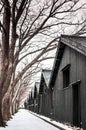 Vintage old Japanese black warehouse in winter snow and tree lin