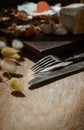 Vintage old metal knife with fork and Dried rabbit tail grass flowers on old rustic wooden dining table