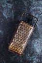 Vintage kitchen grater on a blue grundge background Royalty Free Stock Photo