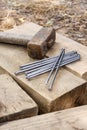 Vintage old rusty hammer and nails lying on wooden bars Royalty Free Stock Photo