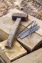 Vintage old rusty hammer and nails lying on wooden bars Royalty Free Stock Photo